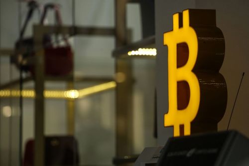 The Bitcoin logo in a shopping center in Tbilisi, Georgia, on Monday, July 25, 2022. A buzz is building in crypto-investor circles and on Twitter about Bitcoin’s stealth July rally, which has beleaguered investors starting to ponder whether the largest digital asset has found a bottom. Photographer: Valeria Mongelli/Bloomberg