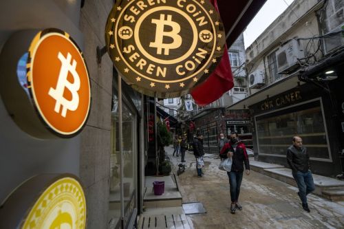 A bitcoin logo sign outside a cryptocurrency exchange kiosk in Istanbul, Turkey, on Monday, Nov. 8, 2021. Bitcoin and Ether hit all-time highs in a cryptocurrency rally that some analysts attributed partly to the search for a hedge against inflation. Photographer: Moe Zoyari/Bloomberg